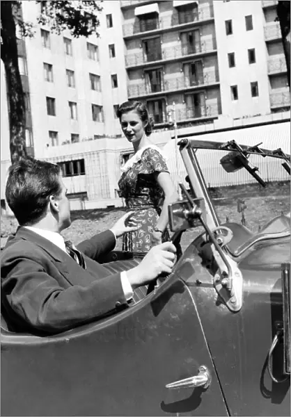Romance. A young man picks his date up in his car. August 1953 D5205-005