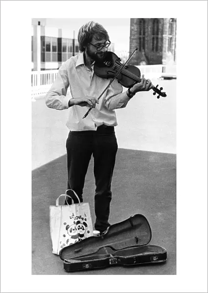 Busker Paul Wright playing his violin