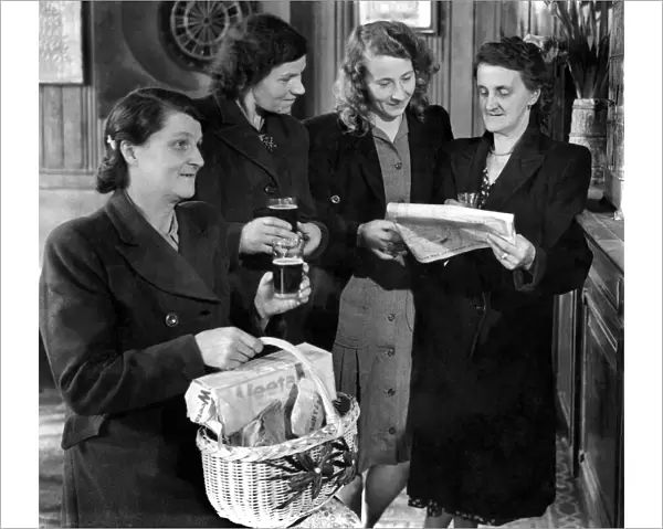 A group of women standing reading the newspaper, one woman in the foreground holding a
