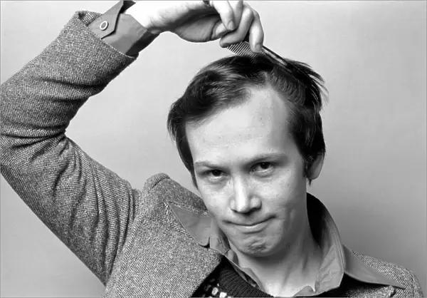 Man combing his hair. July 1975 75-00177-003