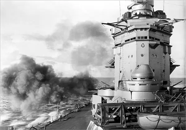 British battleship HMS Rodney of the Royal Navy firing her secondary armament of six inch
