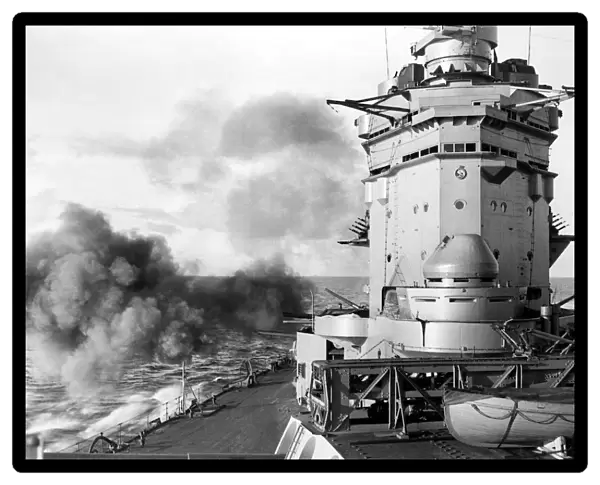 British battleship HMS Rodney of the Royal Navy firing her secondary armament of six inch