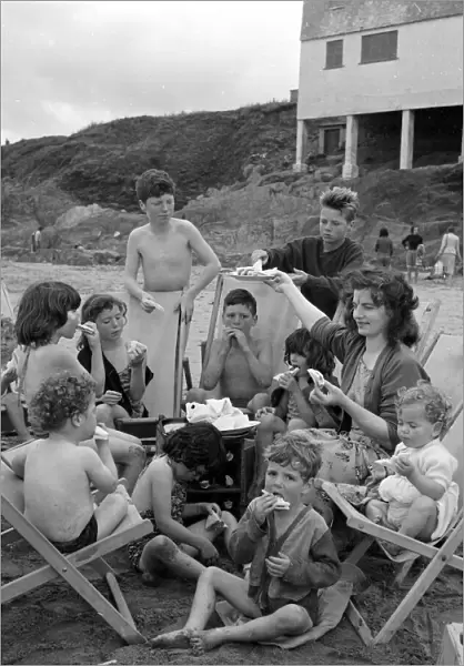 Mrs Mavis Graham and her 12 children seen here having a picnic beside the sea at Bigbury