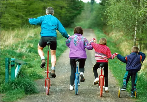 Duncan, Christine, Lisa and Adam on their unicycles near their home in High Spen