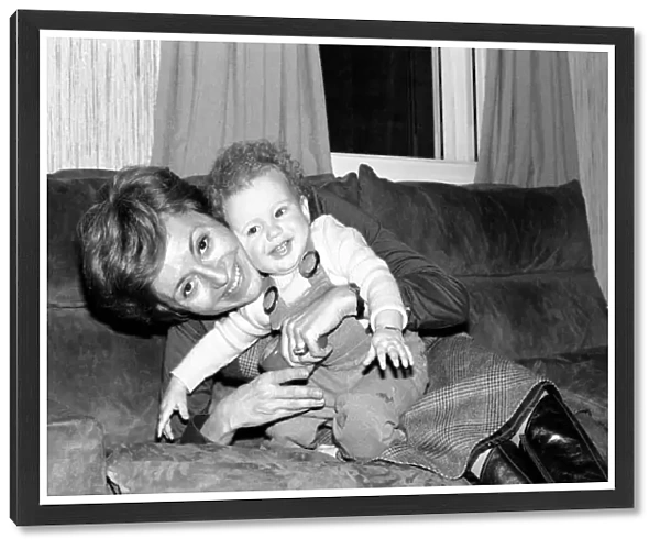 International singer star: Caterina Valente serenades her son. February 1975 75-00827-004