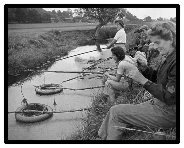Land Army girls learning the acient art of eel clotting near Axbridge, Somerset