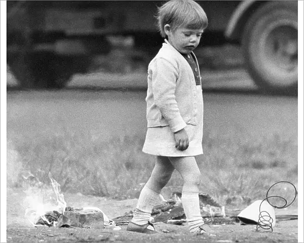 A young girl risks injury playing with fire on wasteland 01  /  11  /  72circa