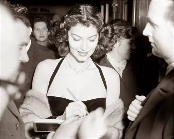 Ava Gardner signing autographs at a Midnight Matinee at the Colliseum, December 1951