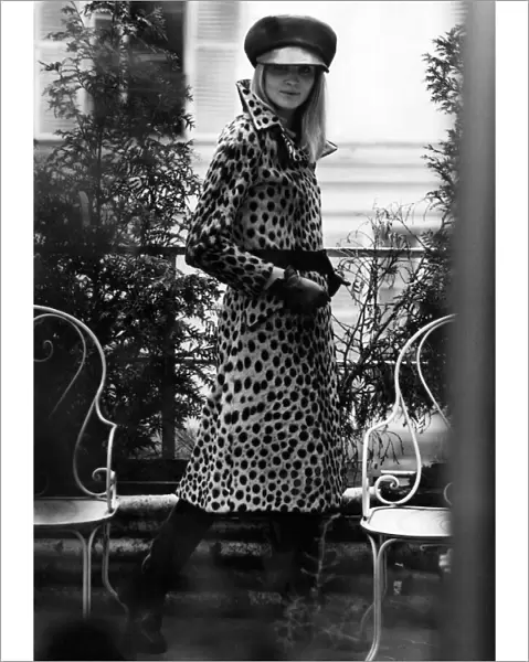 Seen behind bars, a mannequin modeling a leopard skin fur coat. July 1967 P006368