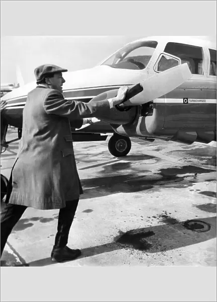Managing Director Freddie Laker (40) pushes his own aircraft back off the airfield apron