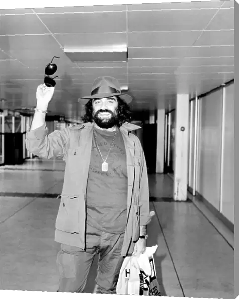 Demis Roussos leaving Heathrow Airport for Abu Dhabi. He is with a show