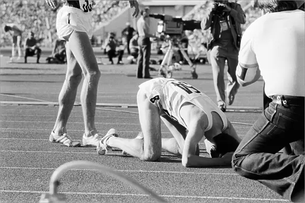 Sebastian Coe collapses to the ground with relief after winning the Mens 1500 metres