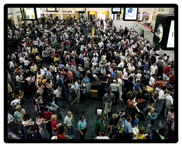 Crowd of passengers wait for their flights which are delayed July 1989
