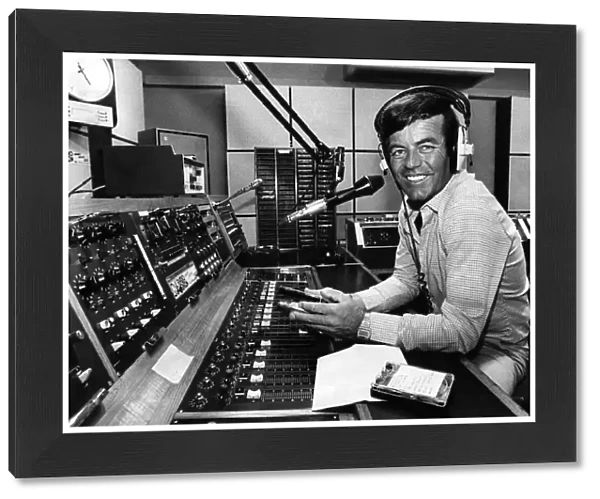 Radio One disc jockey Tony Blackburn behind the record decks spinning the discs for