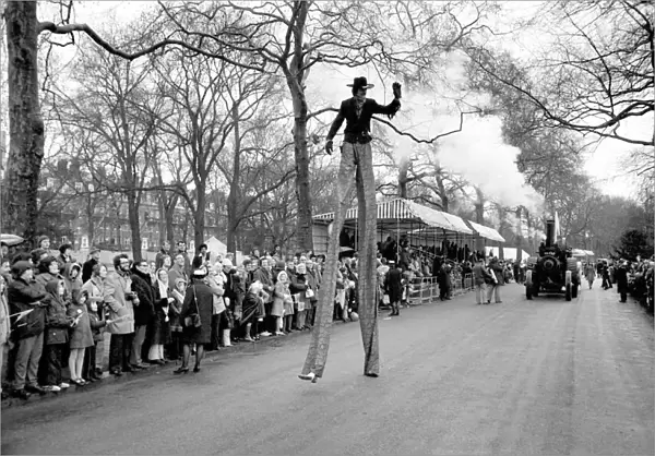 A stilt walker taking part in the Easter parade, Battersea Park. March 1975 75-1706-010