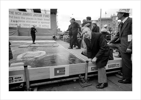 Ross McWhirter at the NCH giant jig saw campaign in Trafalgar Square March 1975