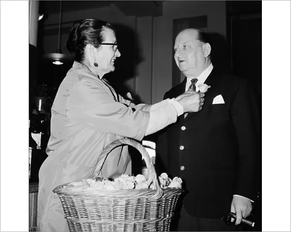 Media Mogul Lew Grade receives a flower frm seller Mrs Louise Noel at Simpsons of