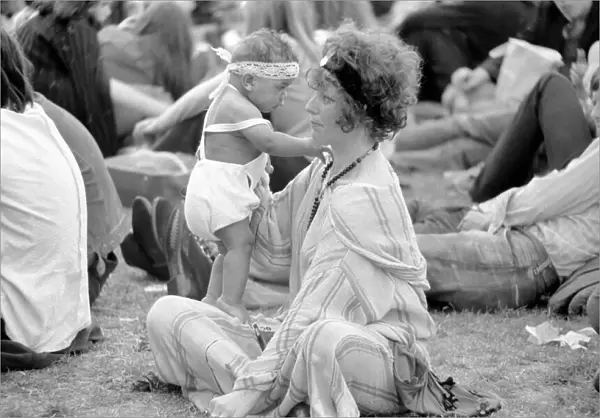Hyde Park Pop Festival. Mother and child enjoy the sunshine on the grass