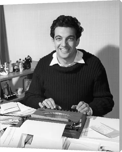 Singer Frankie Vaughan seen here at the typewriter answering some of his fan mail