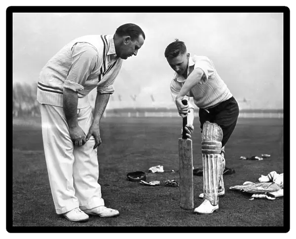 Cecil Pepper gives 22 year old John David Bond of Radcliffe cricket club a few tips