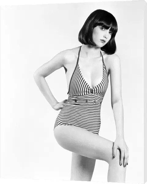 Model Marianne poses wearing striped swimsuitin the studio