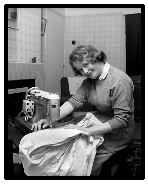 Woman at sewing machine: Mrs. John Theakeston seen here making a dress