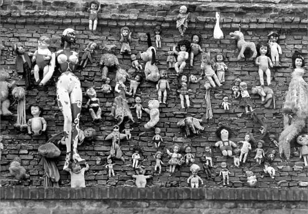 Old dolls on the wall of the Flea Market in Amsterdam. May 1975