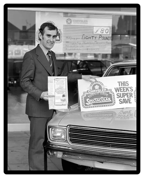 A car dealer putting cars on sale in his garage forecourt. May 1975