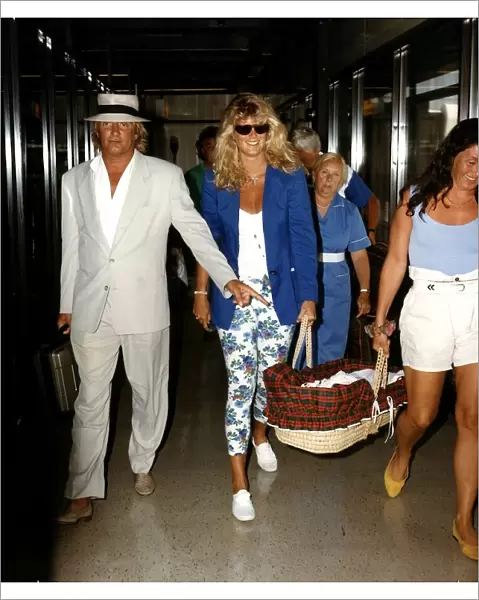 Rod Stewart and Rachel Hunter carring baby Renee arriving at Airport