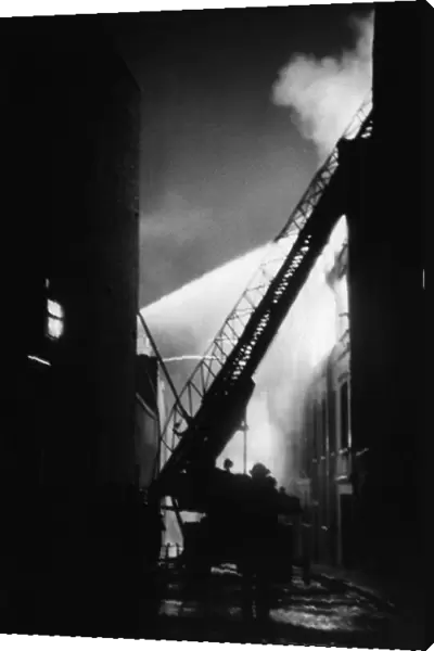 National Fire Service at work on turntable ladders to put out a fire in Brittania Row