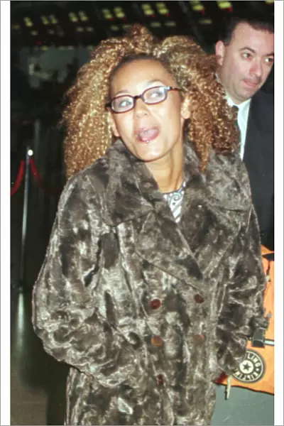 Mel B of the Spice Girls showing the two rings in her tongue as she went through Heathrow