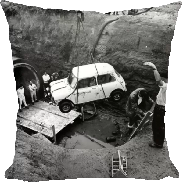 A Mini is lowered into Coventry sewers during the filming of 'The Italian Job'