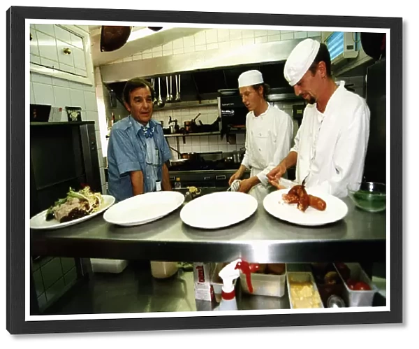 Chef Keith Floyd in a kitchen with Two young chefs. December 1994 *** Local