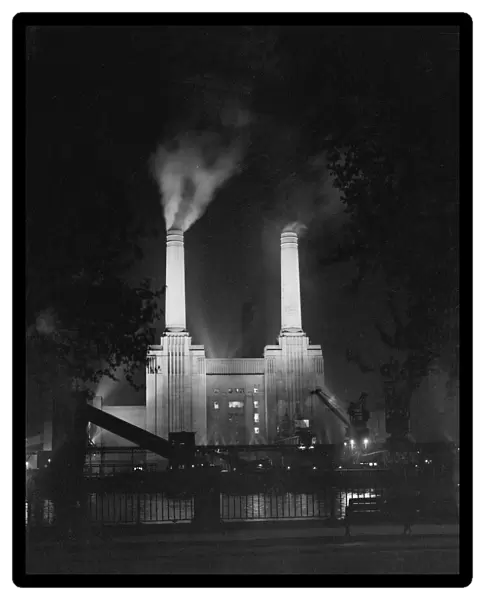 Night time picture of Battersea Power Station lit up on the River Thames, London