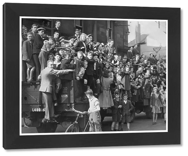 People on the streets celebrate the The VJ day victory parade in Newcastle at the end of