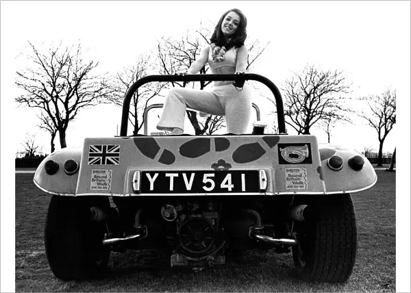 A model in a beach buggy wearing a trouser suit in April 1970