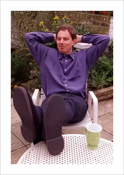Tony Blair Labour Party leader relaxing at home sitting in garden with feet up