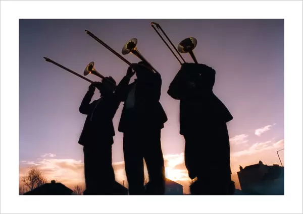 Silhouettes of men playing trombones on December 18, 1997