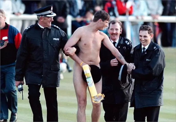 Streaker is arrested by the police after running on to the Old Course at St Andrews