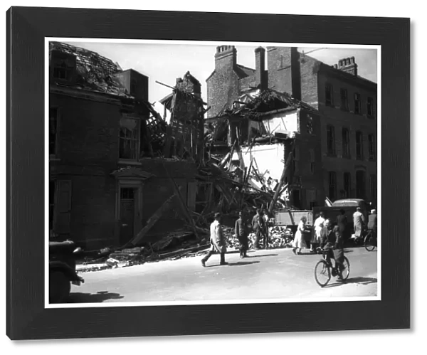 WW2 York Air Raid Bomb Damage Civilians walk pass bomb damaged housing in York as