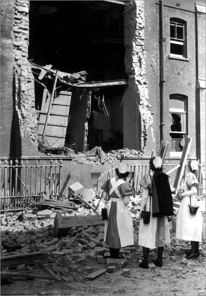 WW2 Air Raid Damage Nurses looking at a bombed hospital building during the blitz