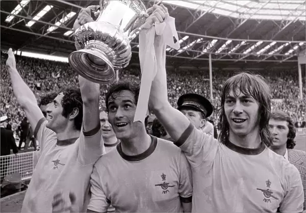 Arsenal team celebrate FA cup final win over Liverpool 1971 as Frank McLintock