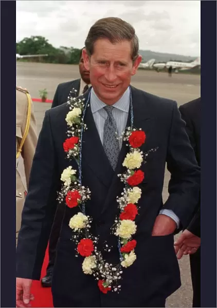 Charles Prince of Wales, October 1997 Arrives in Swaziland with flower garland of