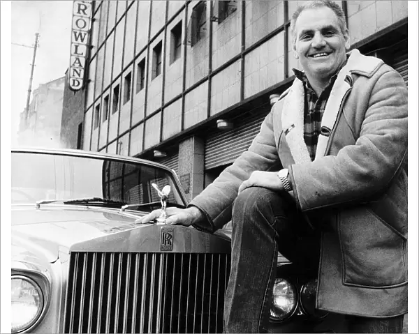 Boxing promoter Alex Morrison standing next to Rolls Royce outside the Barrowlands in