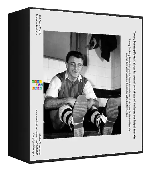 Tommy Docherty Football player for Arsenal who shows off his boots that helped him win