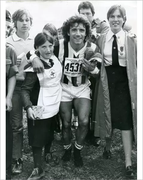 Kevin Keegan being helped by Red Cross girls in the Great North Run 1981