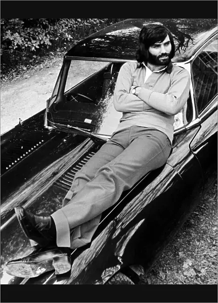 George Best relaxes on car after a drive in the country May 1974 D. Hutchinson