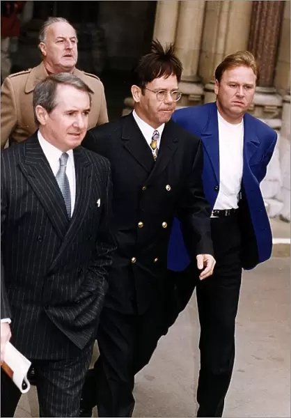 Elton John singer leaves the High Court during the libel court case against The Sunday