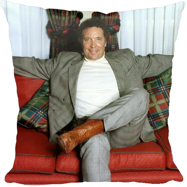 Tom Jones Singer sitting on a couch