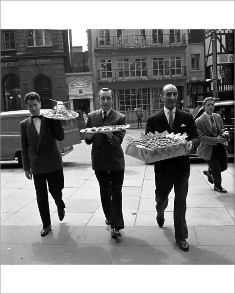 Restaurant men from the Caprice on their way to the Law Courts to serve lunch to